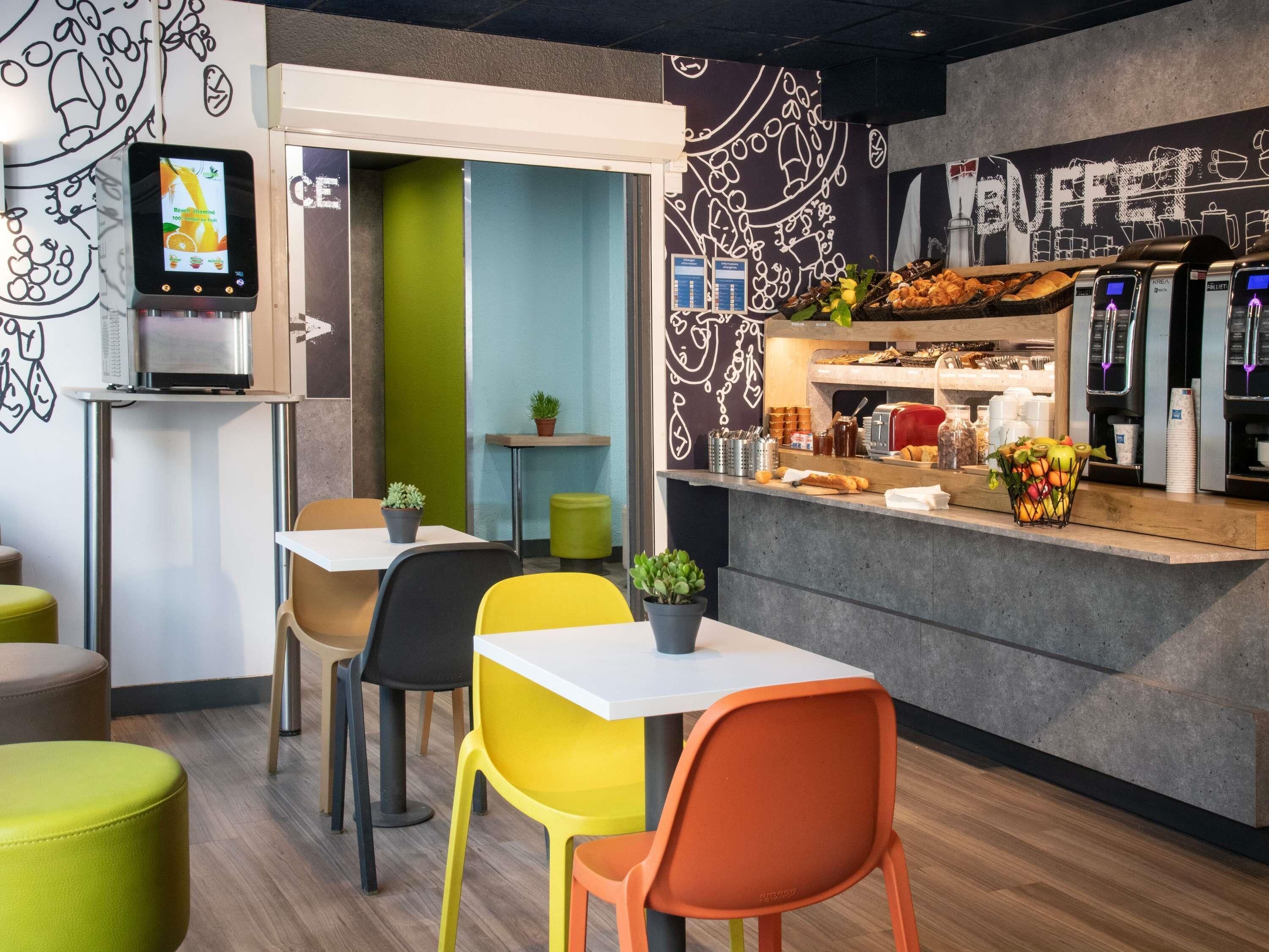 A café with a counter, seating area, and a coffee machine.