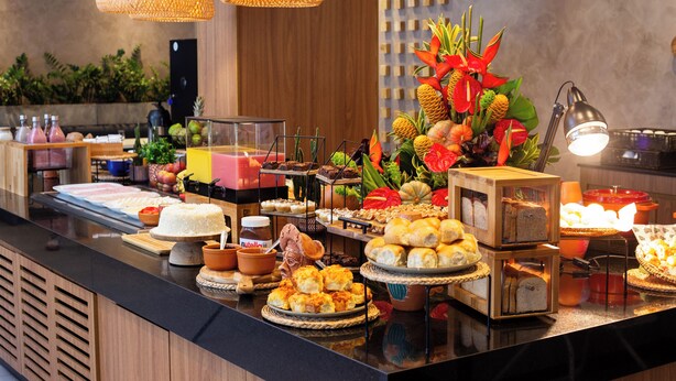 A buffet with various food items and a decorative centerpiece.
