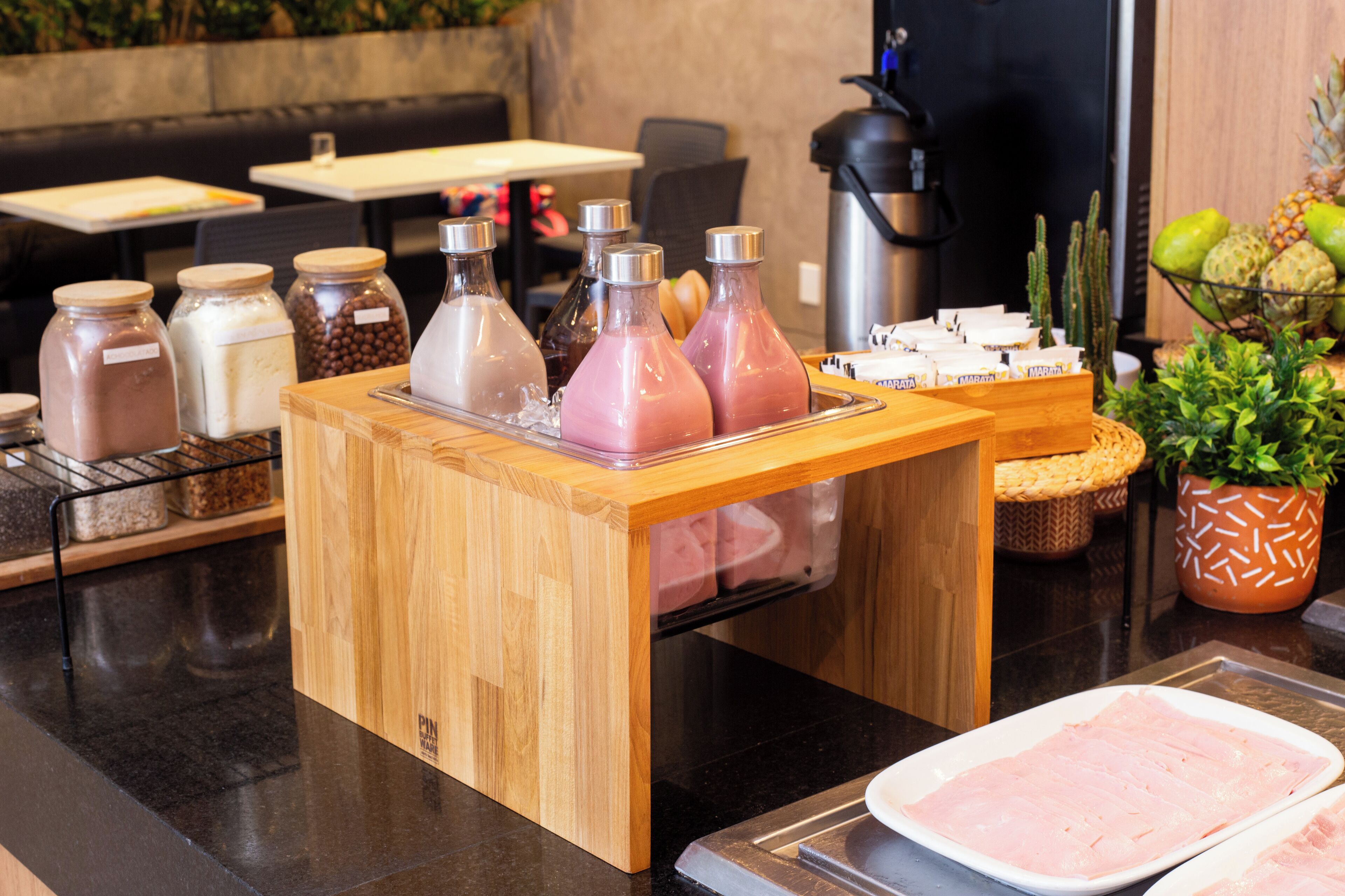 A buffet setup with various food items and condiments.