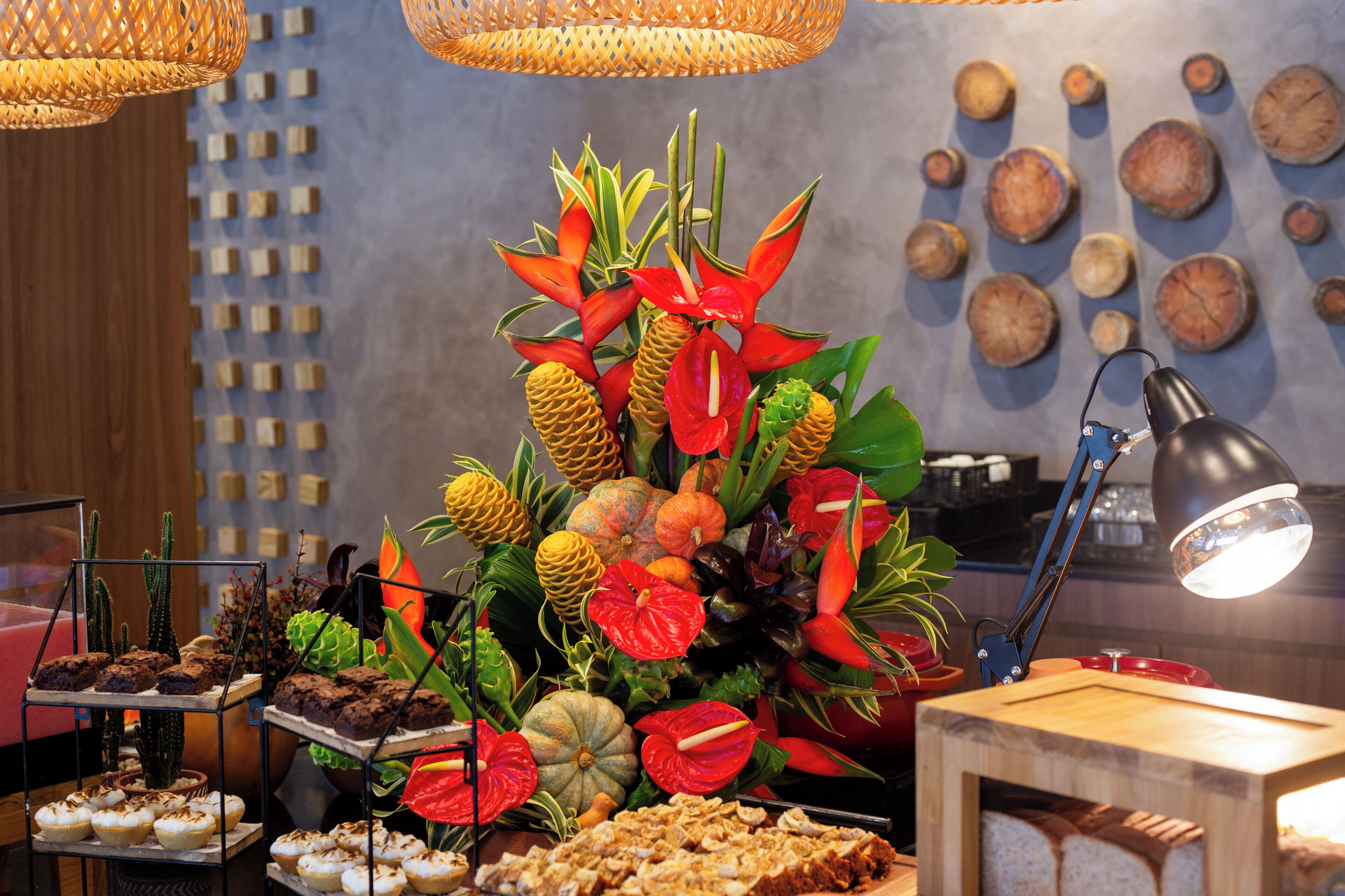 A buffet with various food items and a decorative centerpiece.