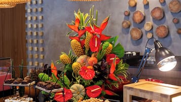 A buffet with various food items and a decorative centerpiece.