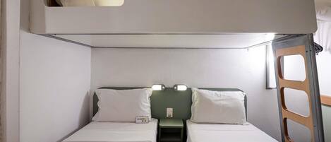 A bunk bed room with two beds and a small table.