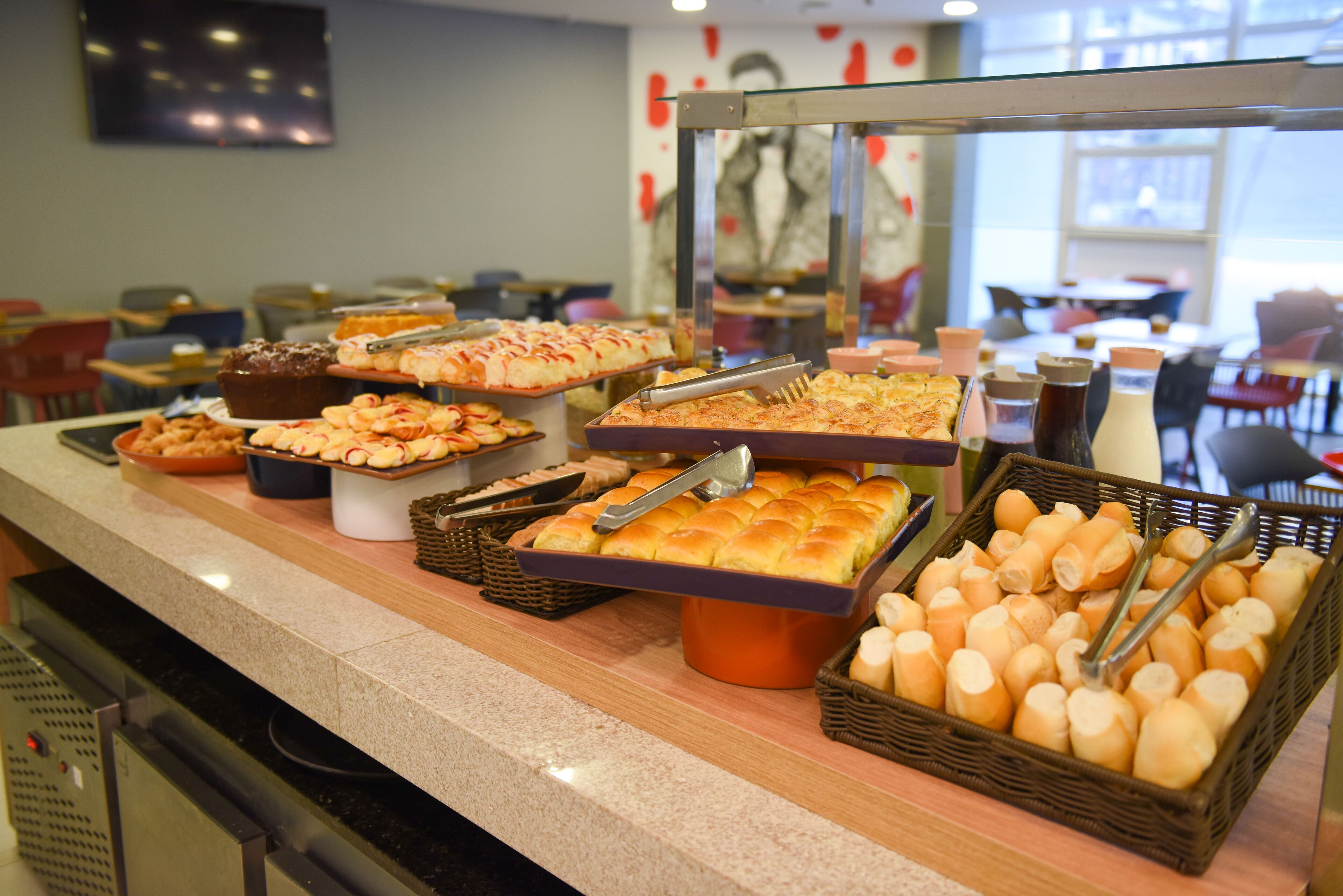 A buffet with various baked goods and pastries.
