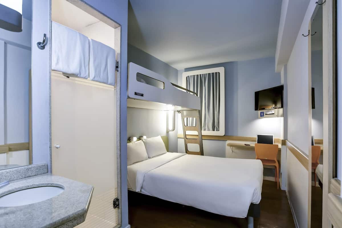 Hypo-allergenic bedding, desk, laptop workspace, blackout curtains