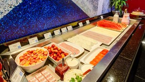 A buffet with various food items and condiments. - ibis budget Rj Copacabana (Rio de Janeiro)