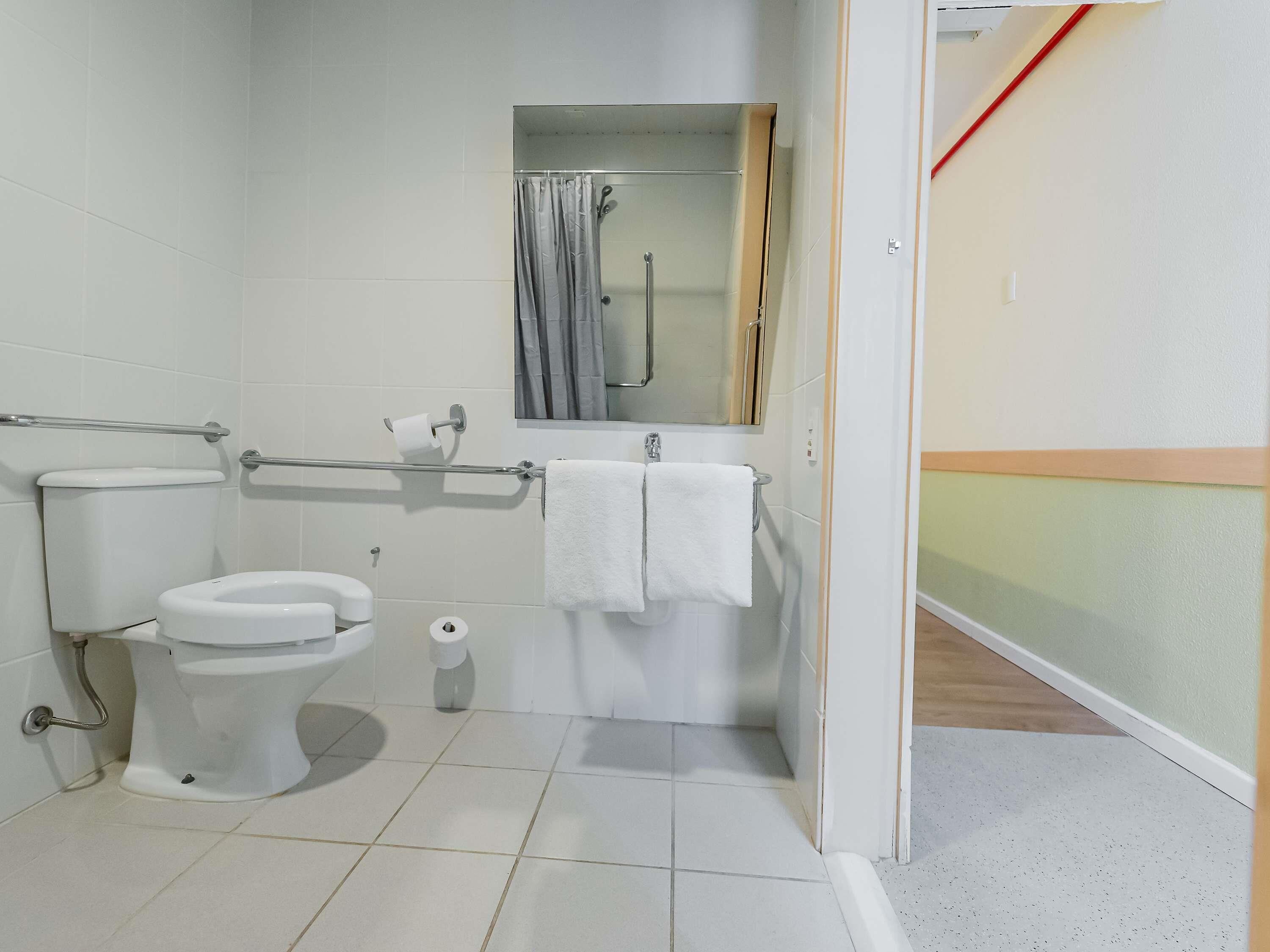 A bathroom with a toilet, bidet, and shower area.