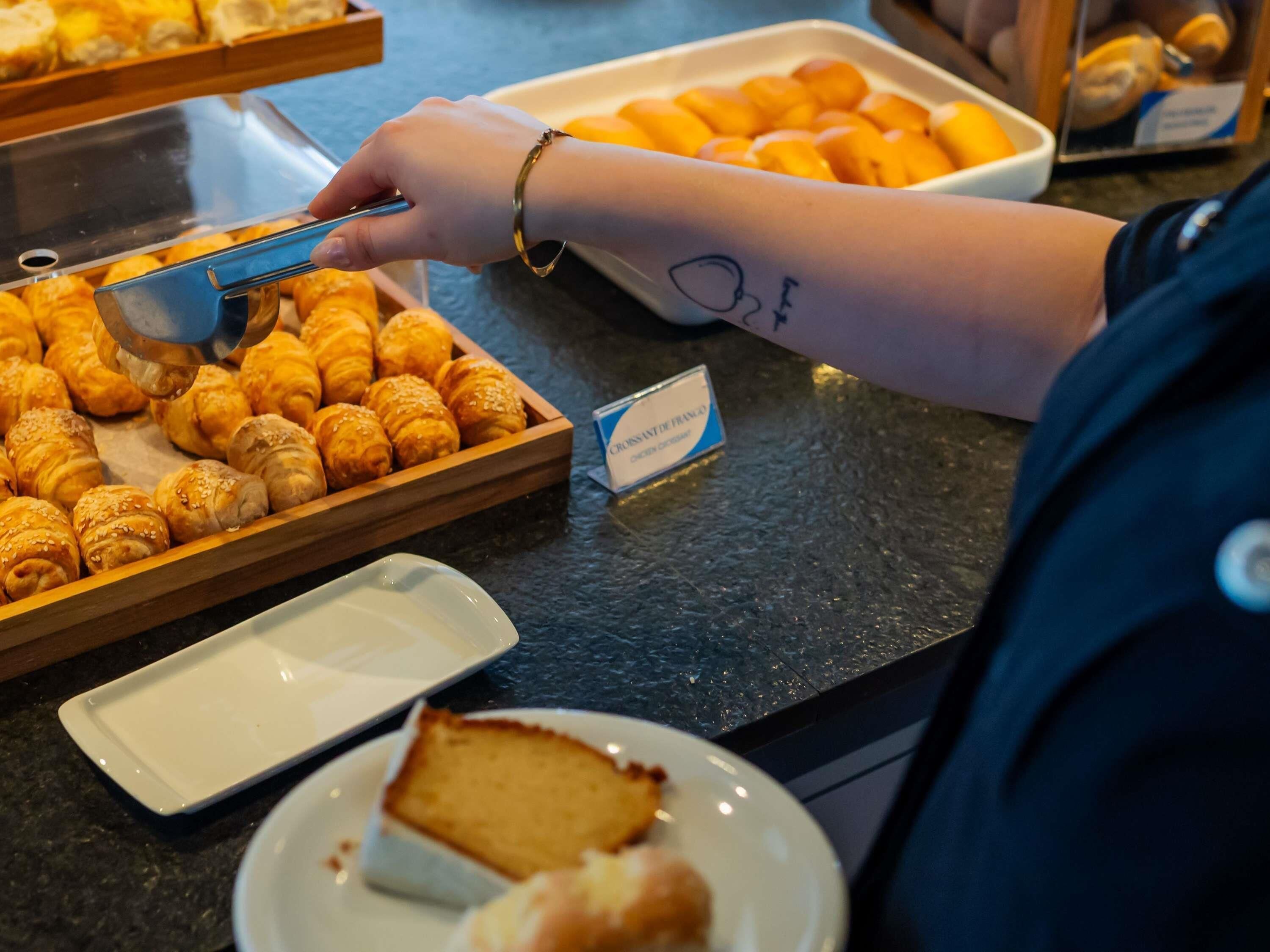 A buffet with various pastries and a cake.