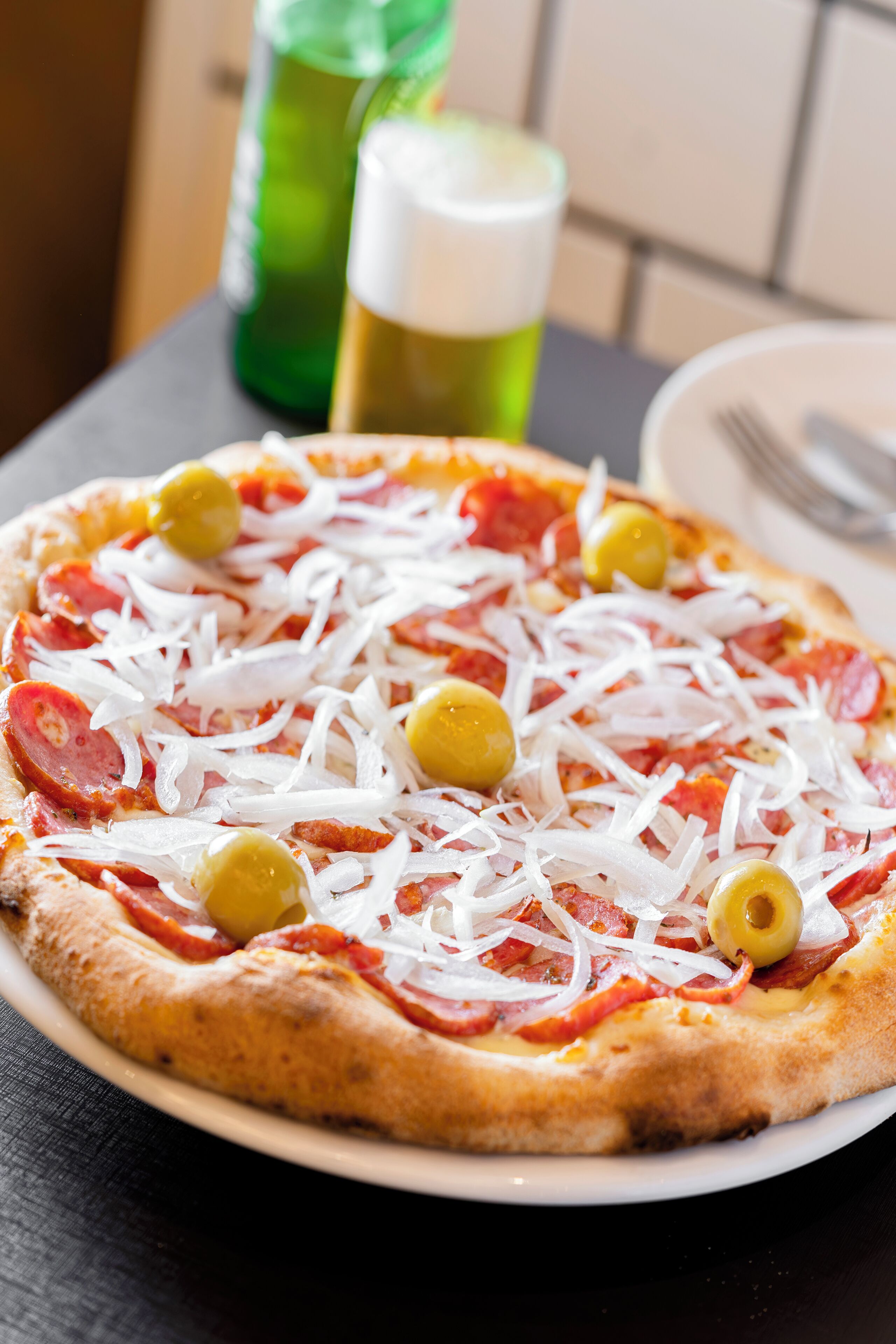 A pizza with toppings on a plate.