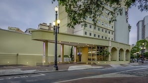 A hotel with a modern facade, multiple floors, and a covered entrance area. - Ibis Budget SP Centro São João (São Paulo)