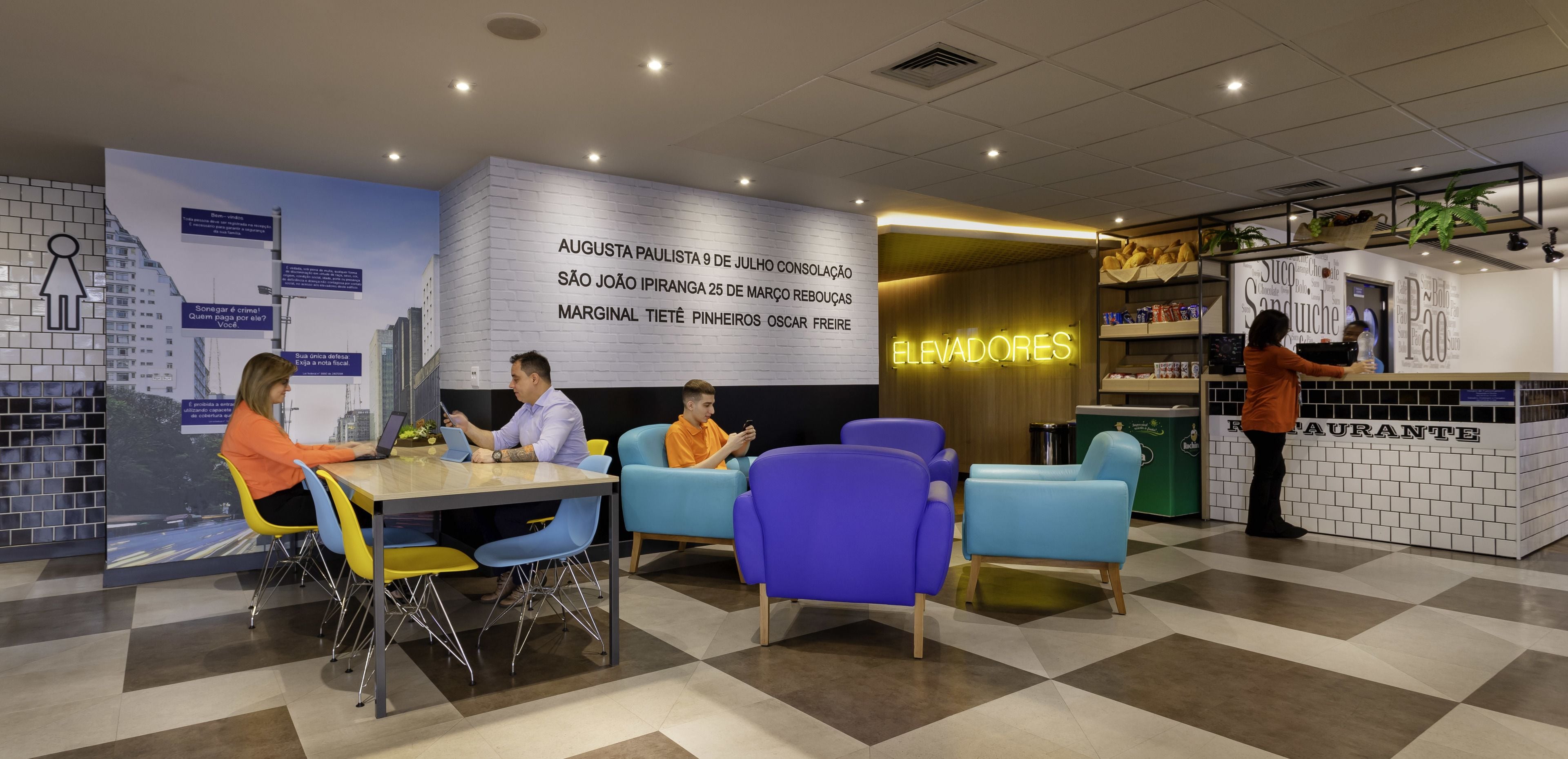 A modern interior with a seating area, a counter, and a wall with text.