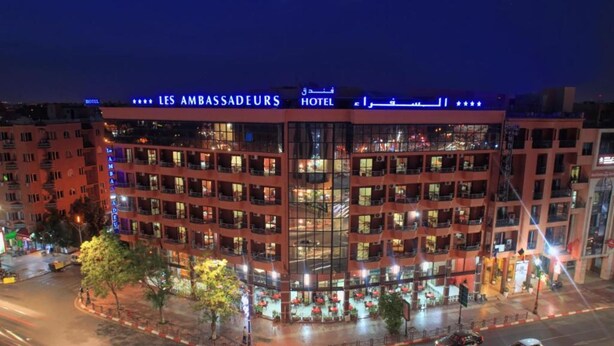 A multi-story hotel with a prominent sign reading "LES AMBASSADEURS HOTEL". - Les Ambassadeurs Appart Hotel (Marrakech)