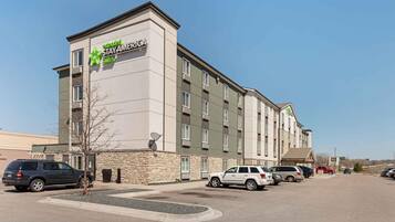 A multi-story hotel with a sign for 'extended stay' accommodations.