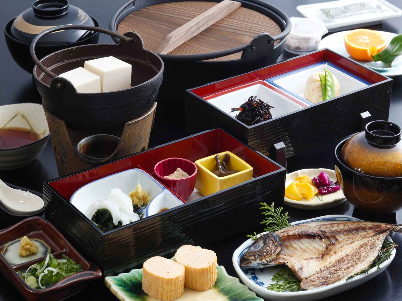 A traditional Japanese meal setup with various dishes and utensils.