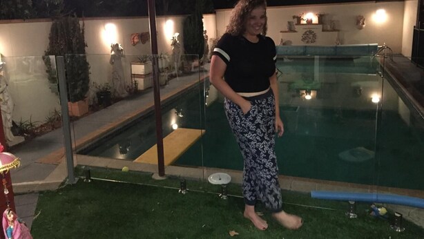 A person standing by a swimming pool at night. - The Evergreen B&B (Braddon)