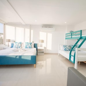 A modern hotel room with a bed, a sofa, a staircase, and a window. - Indila Boracay (Boracay Island)