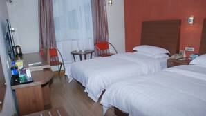 A hotel room with two beds, a desk with a computer, a chair, a small table with a phone and a cup, and a window with curtains. - Ane 158 Hotel Bazhong Branch (Bazhong)