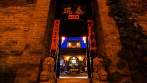 A traditional Chinese gate with a sign above it.