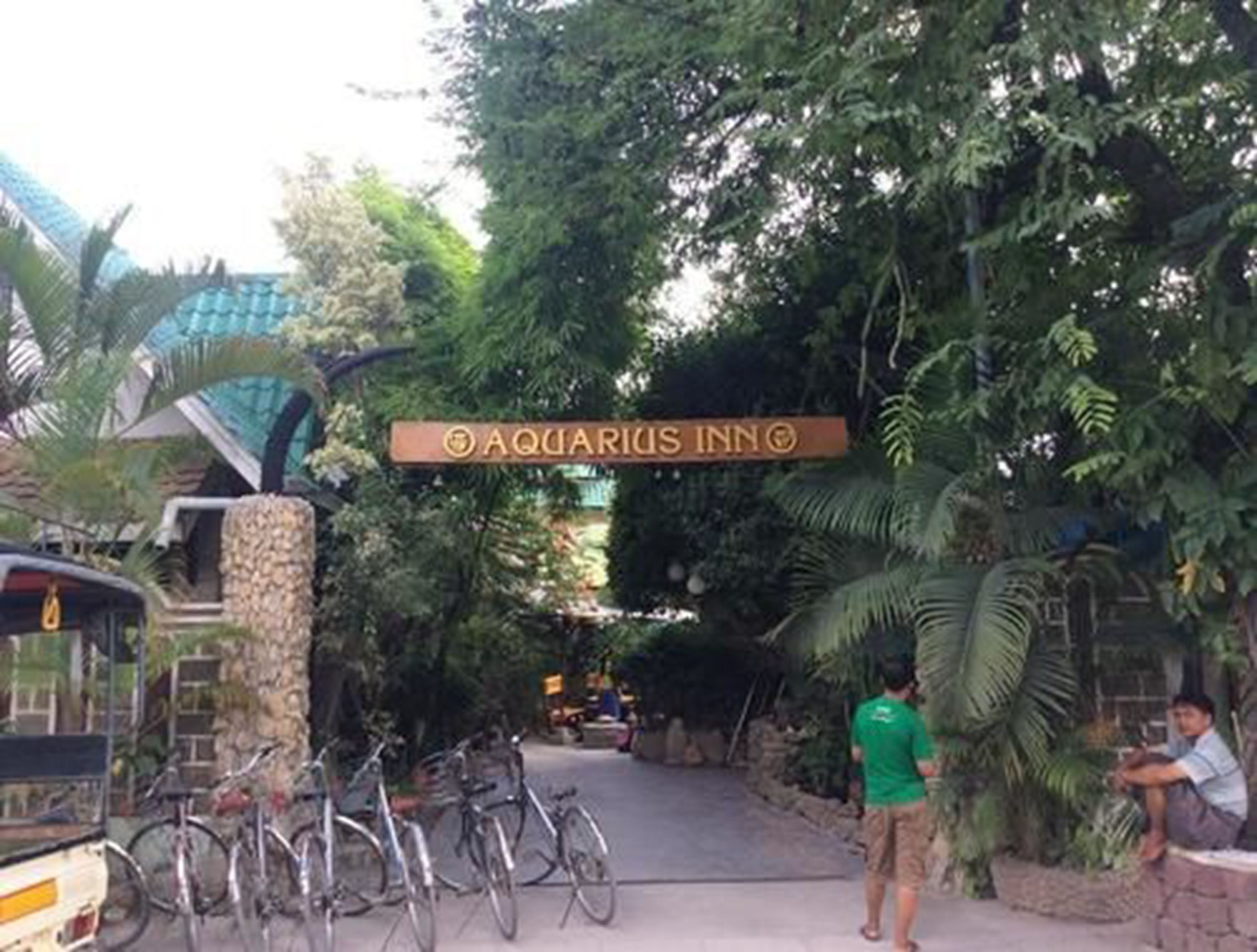A sign for 'Aquarius Inn' with bicycles parked nearby.