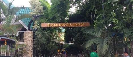 A sign for 'Aquarius Inn' with bicycles parked nearby.