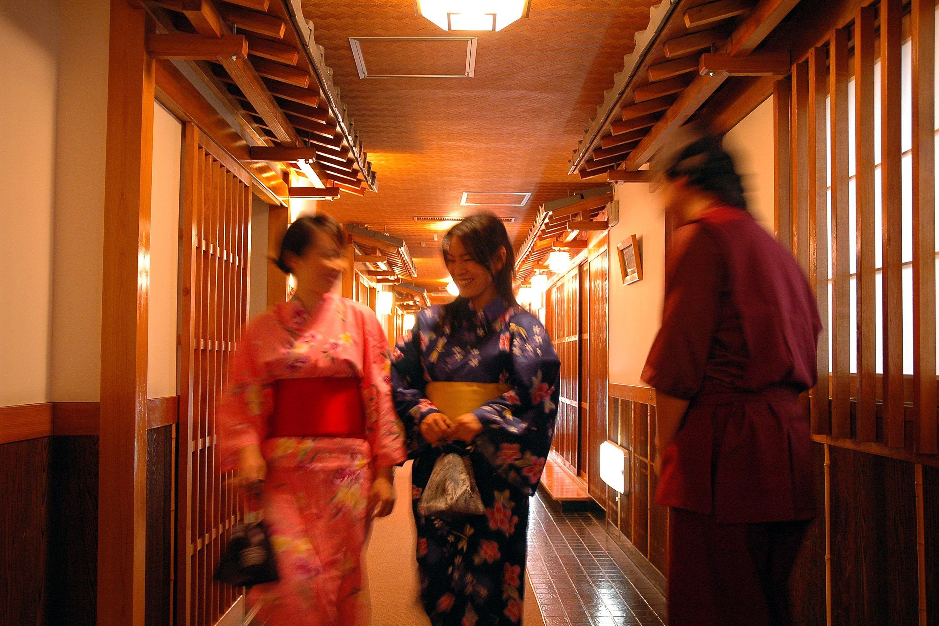 A corridor with wooden paneling and a ceiling light fixture.