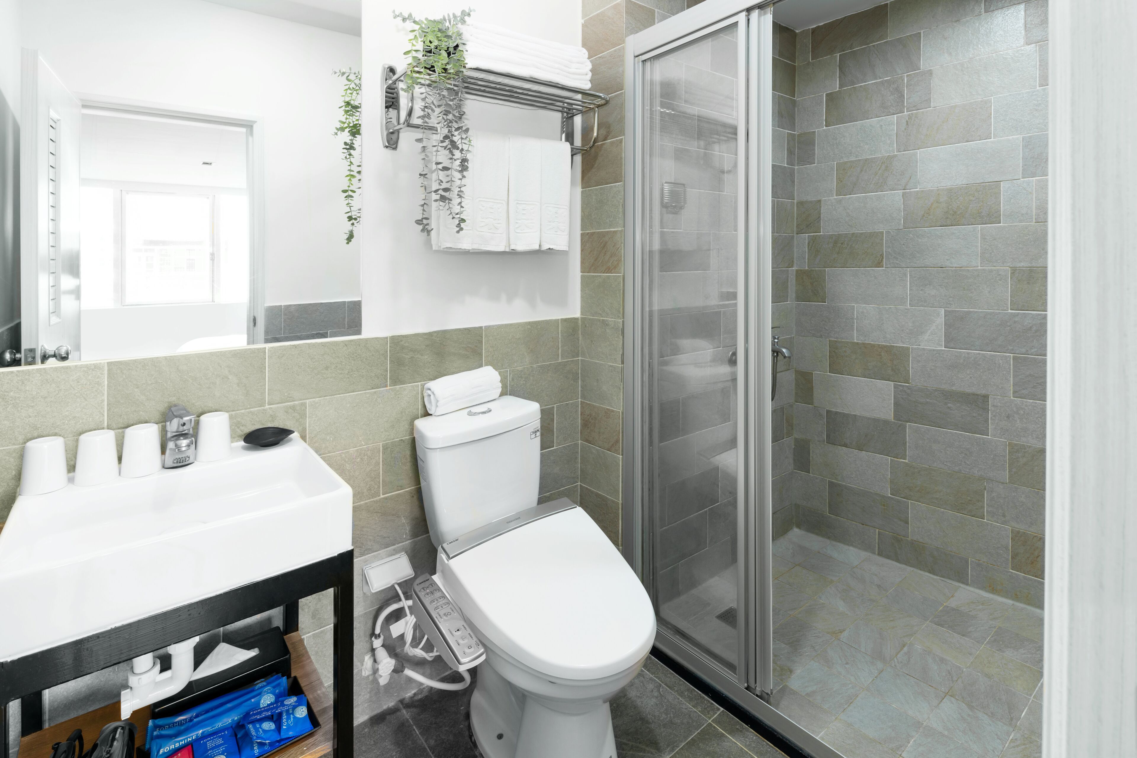 deluxe quadruple room | bathroom | shower, free toiletries, hair dryer, slippers