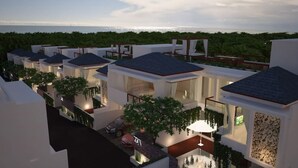 A modern resort with multiple villas, each featuring a balcony with a view of the ocean. - Bali Residence Villa (Ungasan)