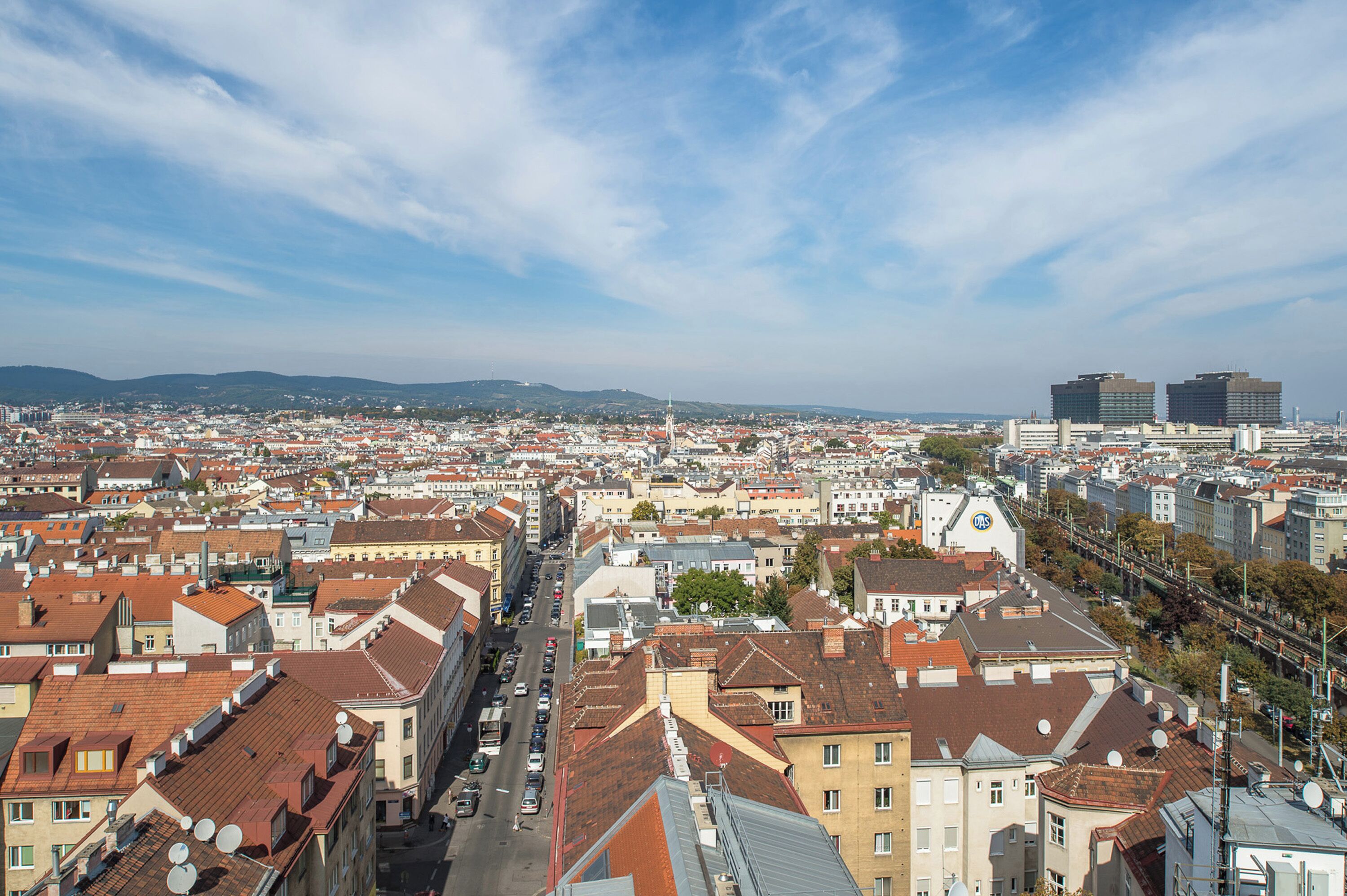 A cityscape with a mix of historic and modern buildings, a prominent church, and a clear sky.