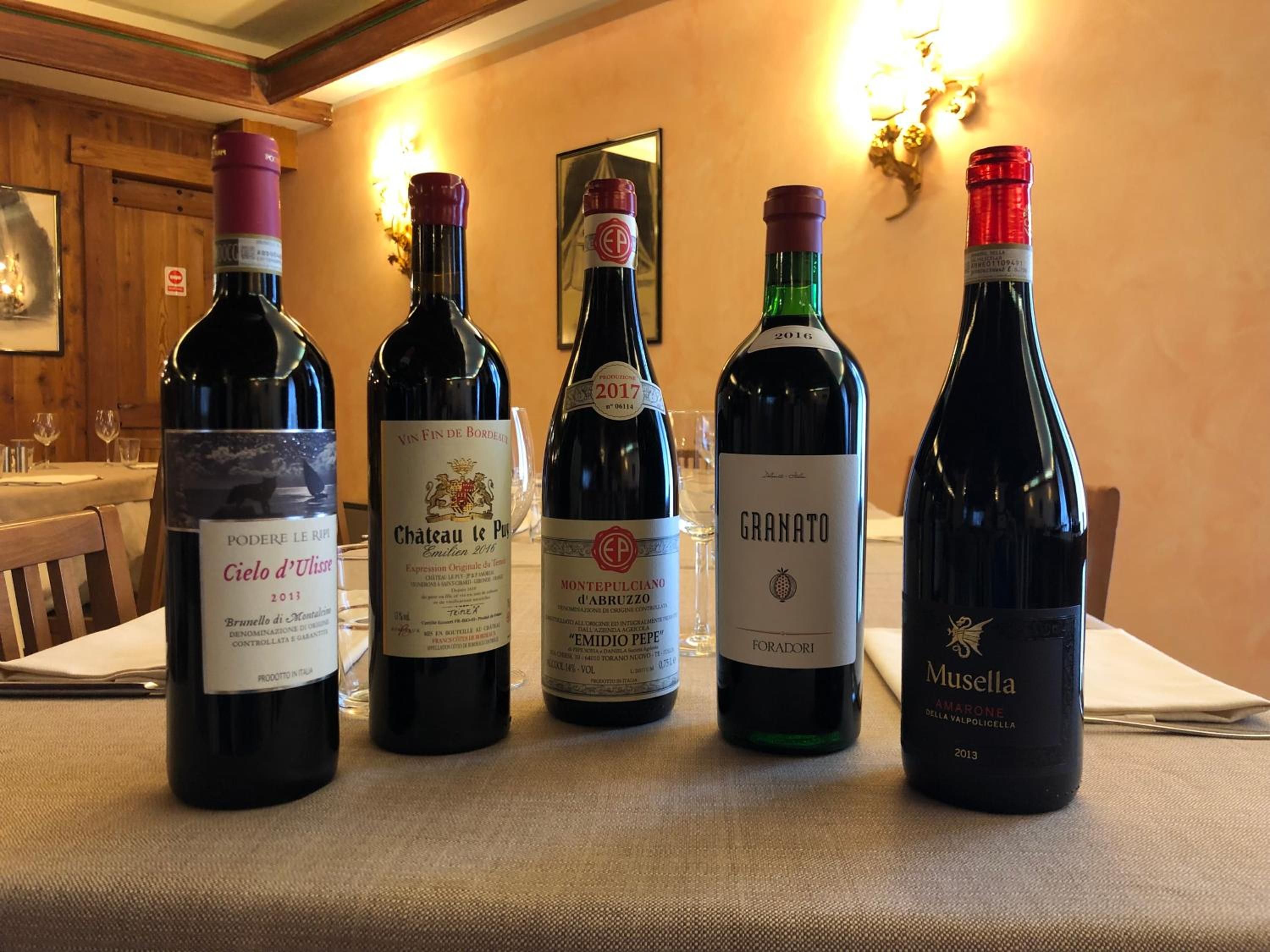 A selection of wine bottles on a table in a dining area.