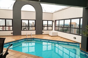 Una piscina techada, sillones reclinables de piscina