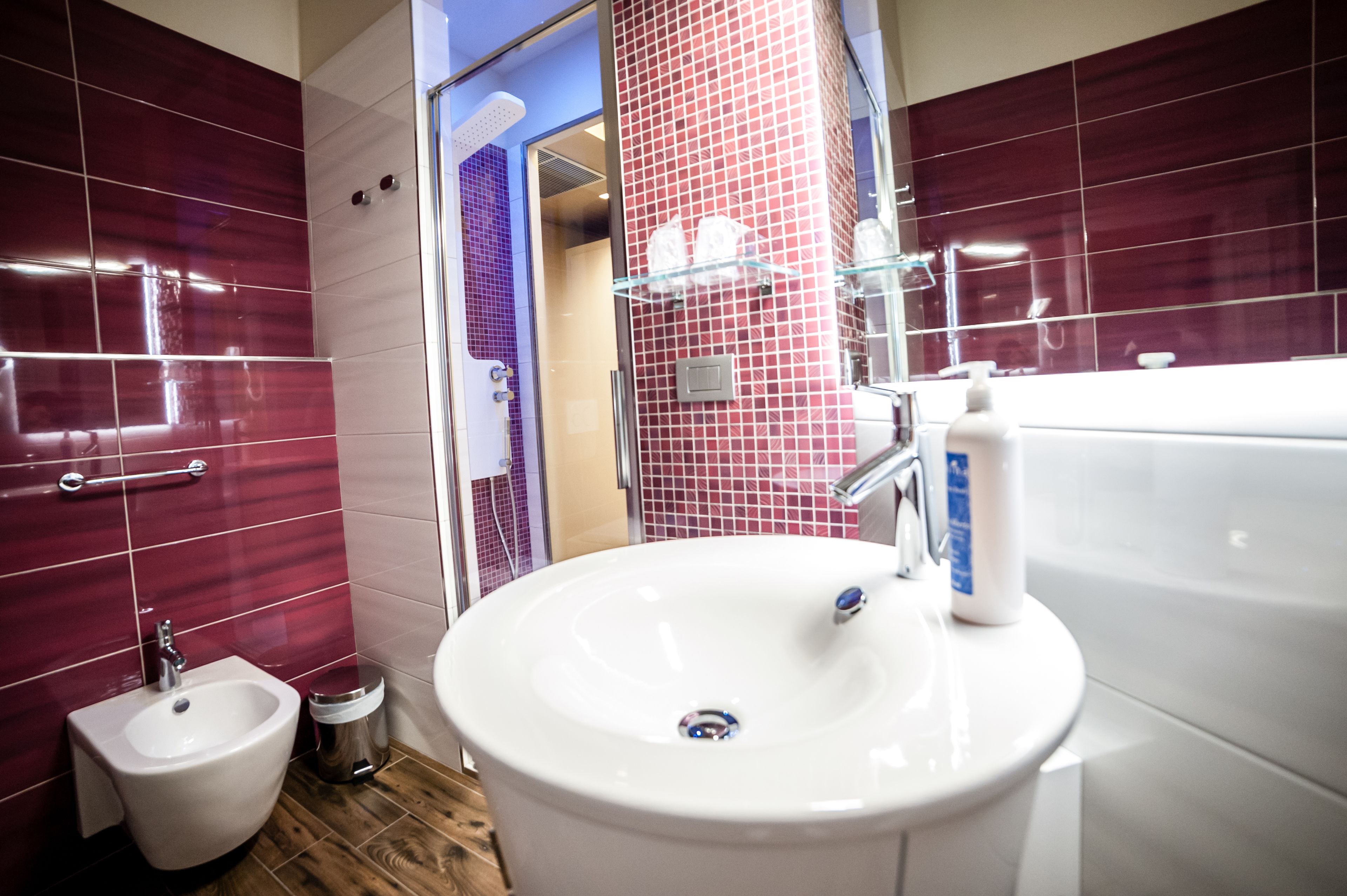 A modern bathroom with a large sink, bidet, and a mirror.