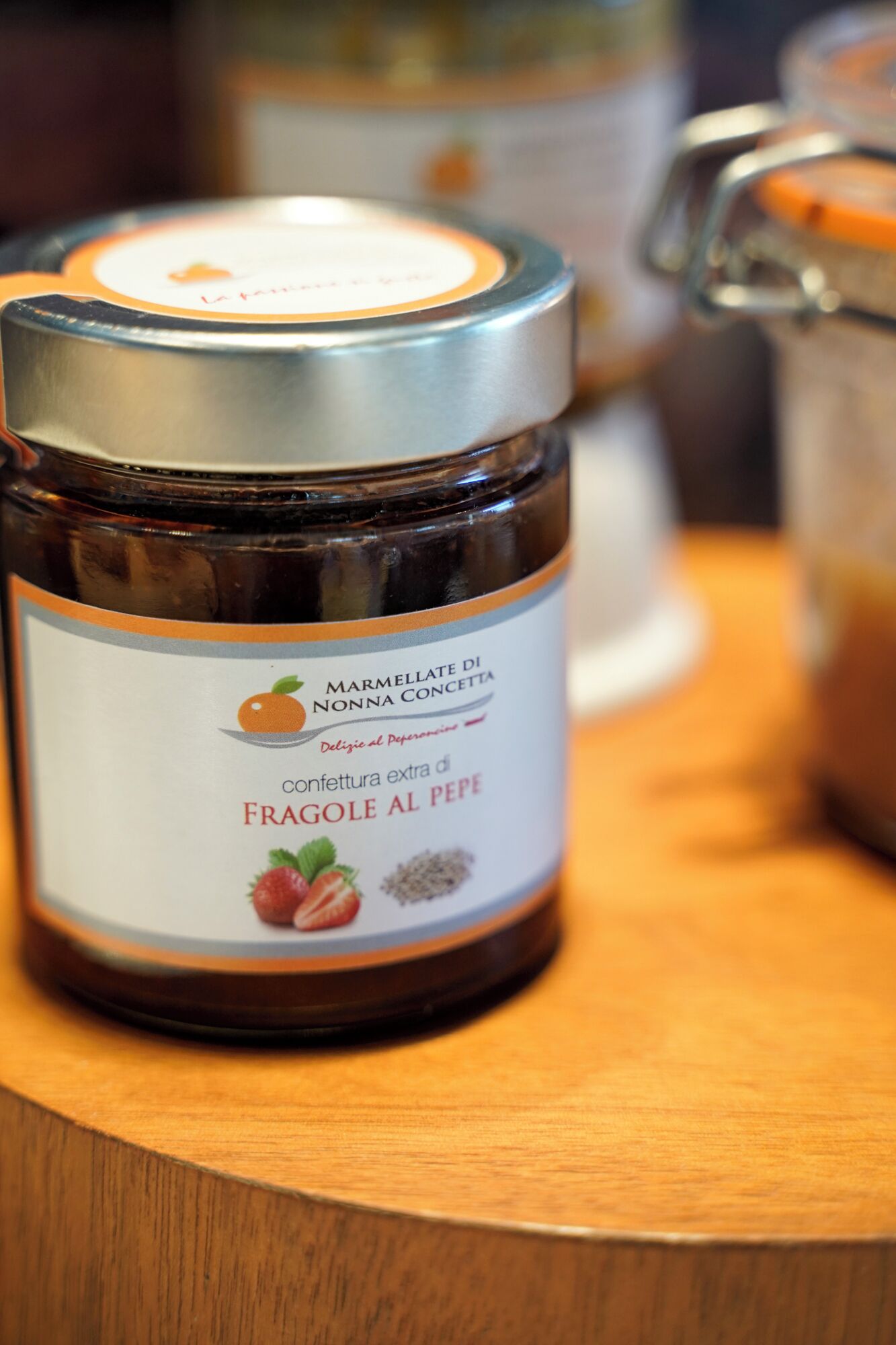 A jar of marmalade on a wooden surface.