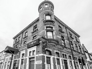 A historic building with a corner turret, multiple windows, and signs indicating 'Trivelles' and 'The Stockwell Mould'. - Trivelles Seaforth (Liverpool)