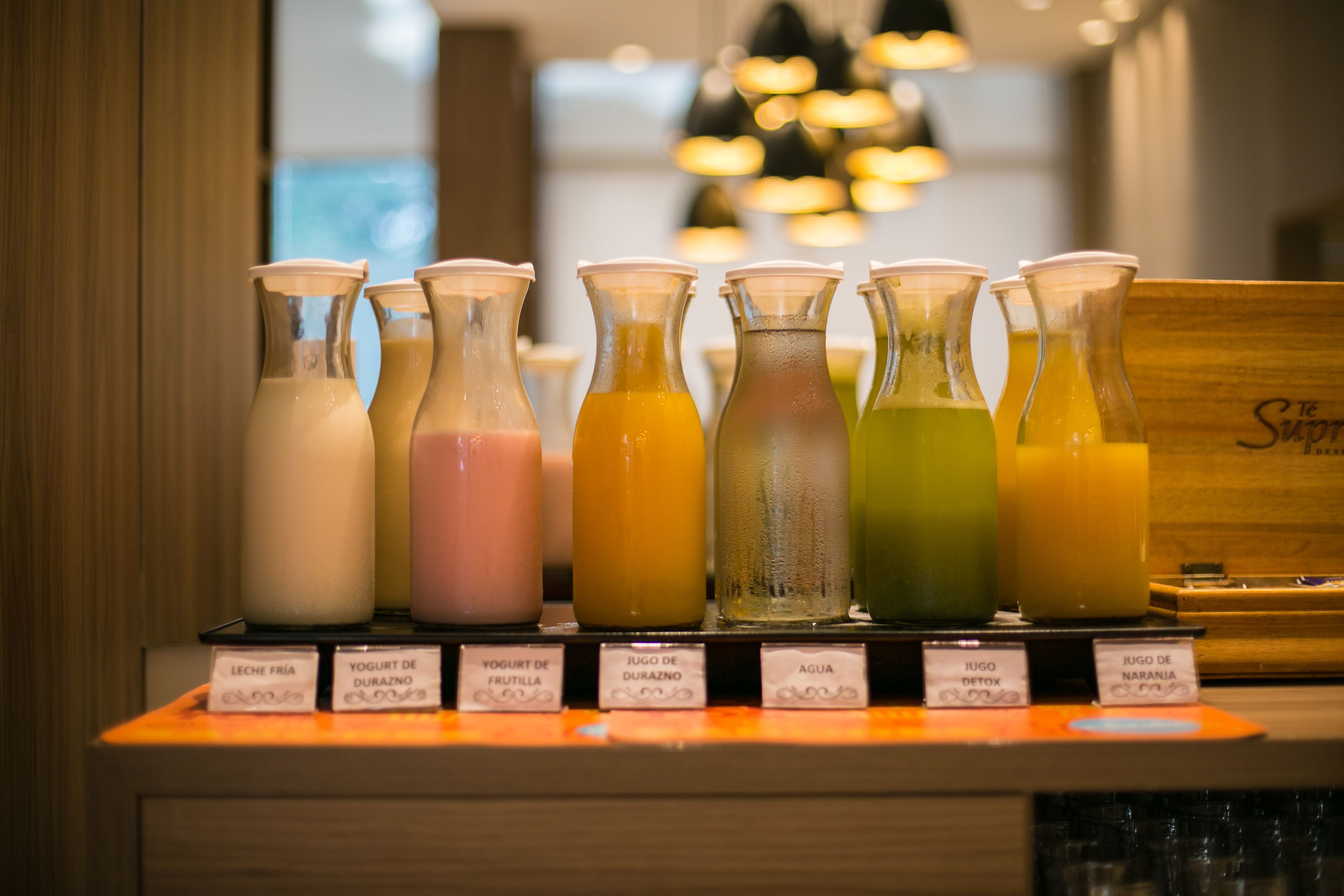 A selection of beverages in glass bottles with labels, arranged on a counter.