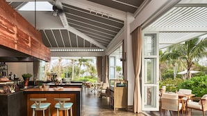 Una cocina amplia con barra, ventanas grandes y vistas al exterior.