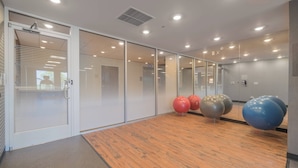 A modern office space with glass partitions, a wooden floor, and exercise balls. - Fairfield Inn & Suites by Marriott Gaylord (Gaylord)