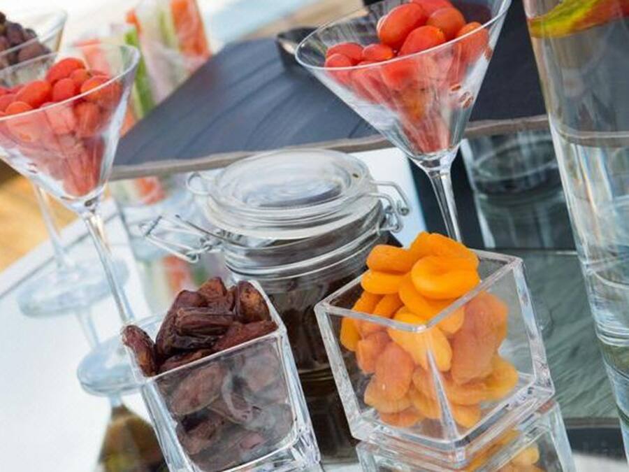 A glass display case with various snacks and a jar of dried fruits.