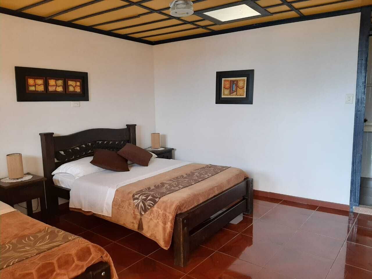 A bedroom with a bed, two bedside tables, and a nightstand.