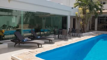 Outdoor pool, open 7:00 AM to 10:00 PM, pool loungers