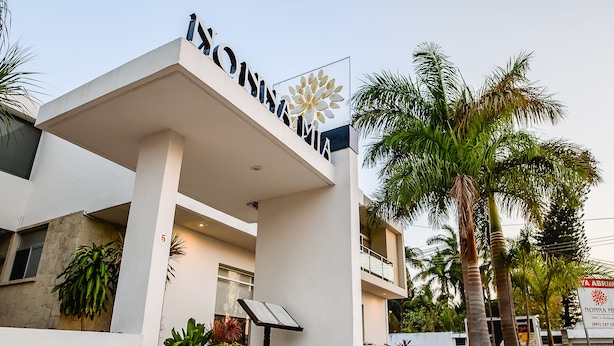 A modern hotel entrance with a sign reading "NONNA MIA". - Nonna Mia (Campeche)