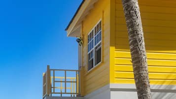 On the beach, white sand, beach cabanas, sun loungers