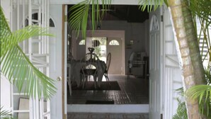 An open doorway leading to a room with a tiled floor, a chair, and a table. - Executive Mamme Bay Hotel and Conference (Ocho Rios)