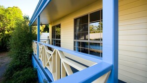 A house with a porch, large windows, and a blue railing. - Springview (Hepburn Springs)