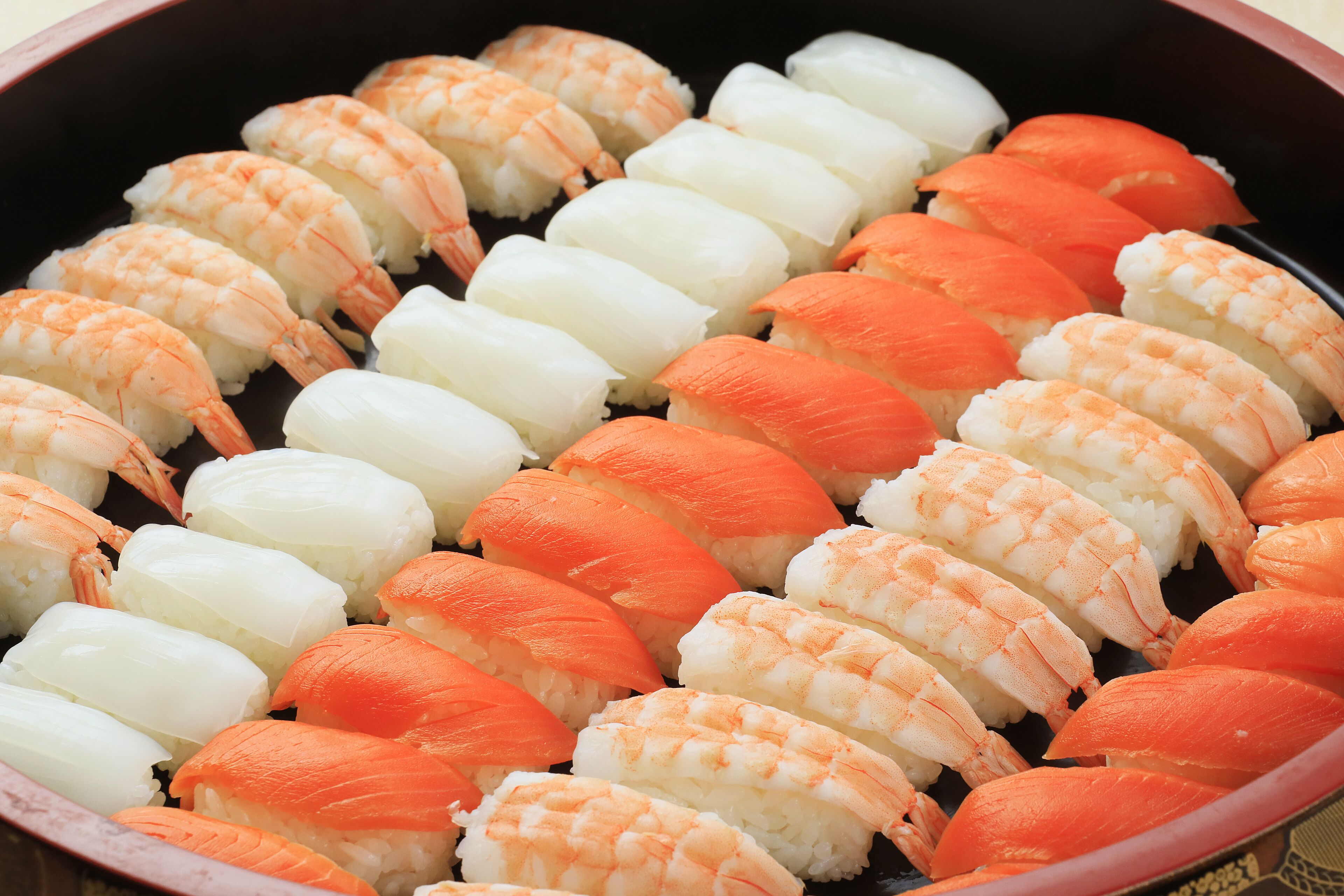A tray of sushi with shrimp and white fish.