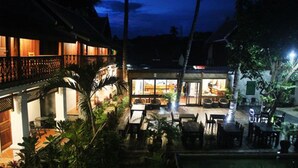 A hotel with a dining area, outdoor seating, and a pool. - Davita Boutique Hotel (Luang Prabang)