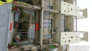 A multi-story hotel with a modern design, featuring balconies, large windows, and a central atrium. - Luckystar B&B (Luodong)