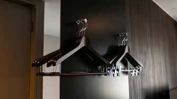A set of wooden coat hooks mounted on a wall.
