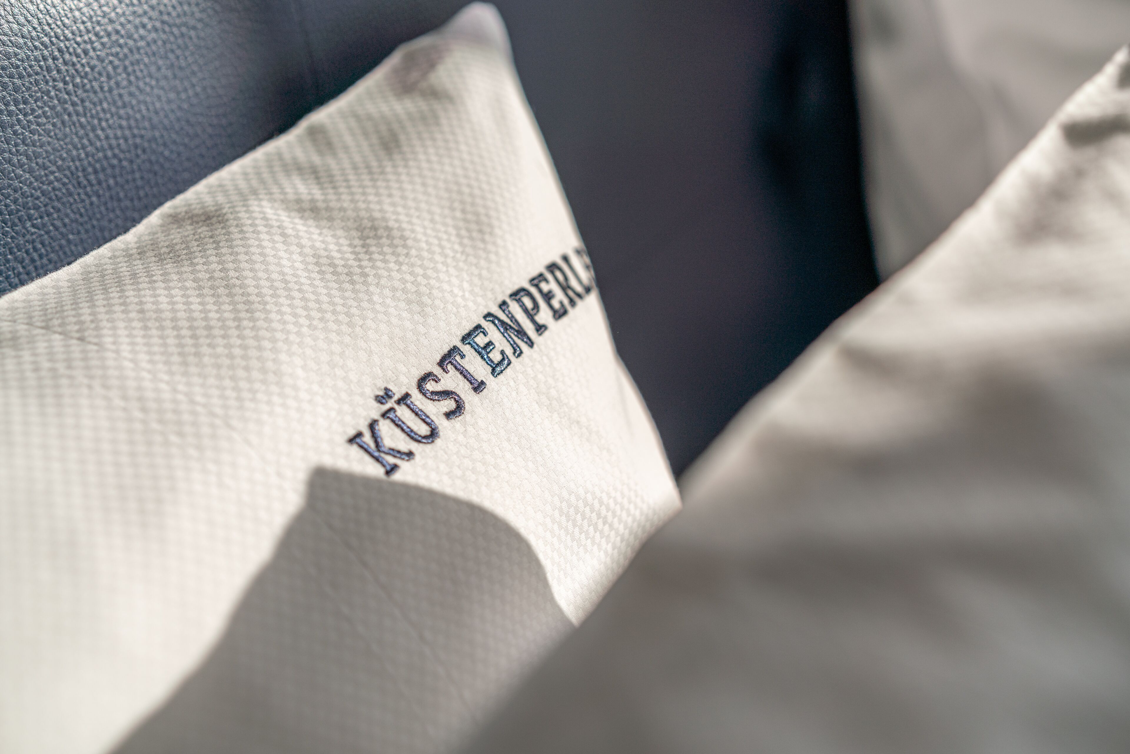 A pillow with the text "KÜSTENBERG" on it.