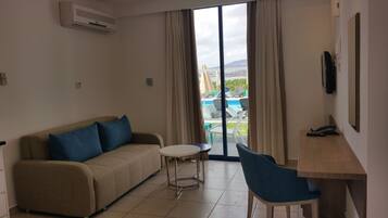 Suite, 1 Bedroom (Sea & Pool View) | Living room | TV