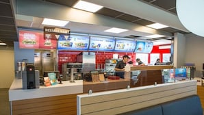 A fast-food restaurant with a counter, menu boards, and seating area. - Hotell Eken (Kållered)