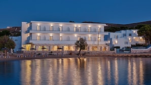 Un hôtel situé sur la côte, doté de nombreux balcons, d’un espace piscine et offrant une vue sur la mer.